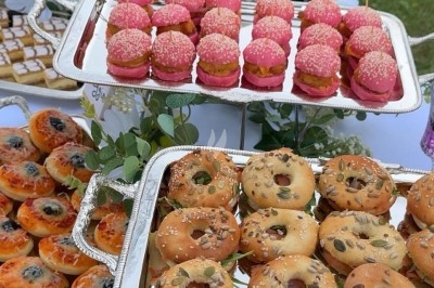 Miniature Traiteur Paris 8 (Paris) - Les Trois Soeurs Traiteur #30 Table de réception élégamment dressée avec chandeliers, fleurs pourpres et vaisselle raffinée dans une salle lumineuse.