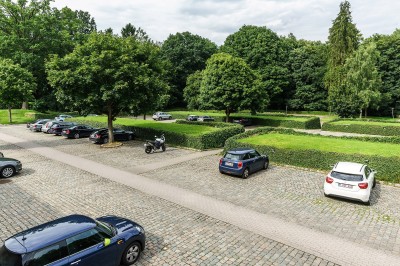 Miniature Le vaste parking Femme assise dans un hammam aux carreaux roses, enveloppée dans une serviette blanche.