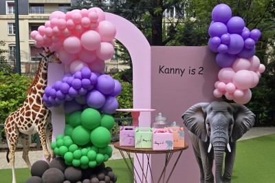 Mur décoratif coloré avec motifs africains, ballons et panneaux portant des messages inspirants en anglais.