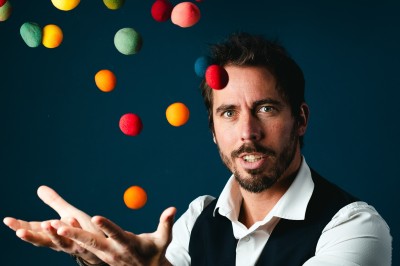 Trois personnes discutent et rient ensemble dans un cadre extérieur convivial.