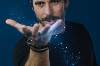 Trois personnes discutent et rient ensemble dans un cadre extérieur convivial.