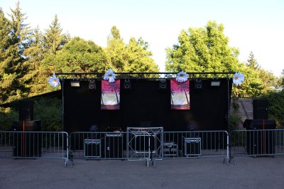 Miniature DJ Toulouse (Haute-Garonne) - Pmn Event #29 Personnes dansant et discutant lors d'une soirée en extérieur, éclairée par des lumières colorées et décorée de guirlandes.