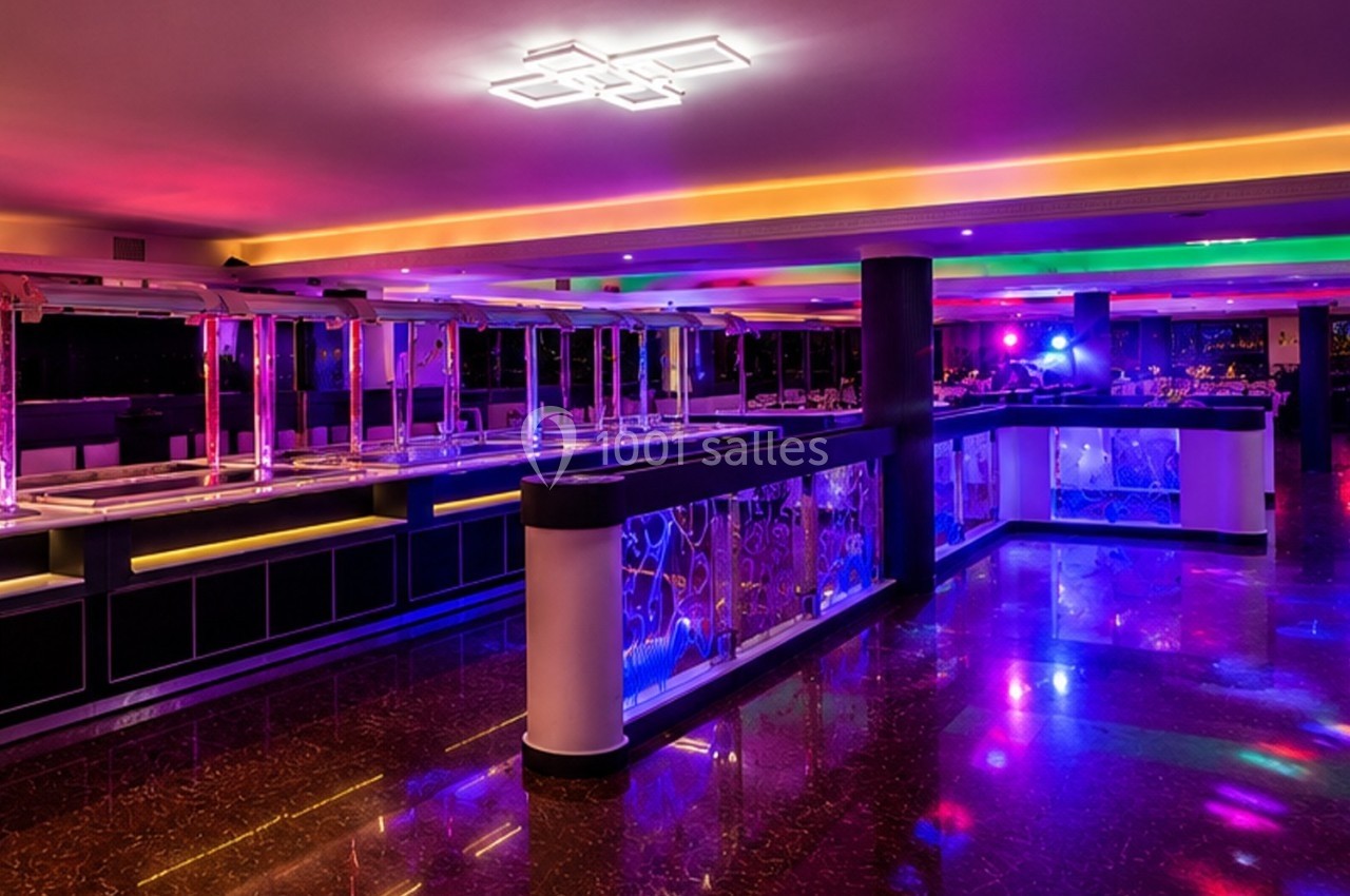 Salle de restaurant moderne avec éclairage coloré, buffet vide et sol en marbre brillant.