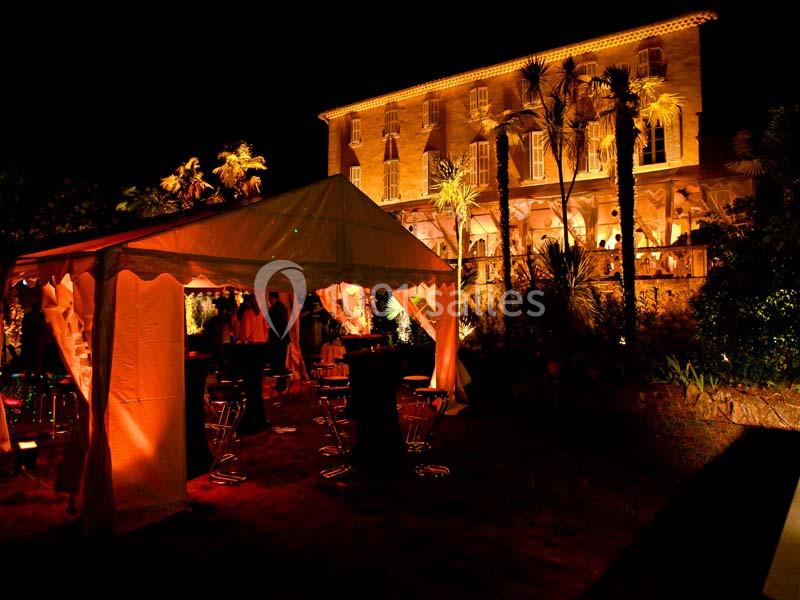 Location salle La Cadière-d'Azur (Var) - Château de Rochebelle - Var #2 Tente éclairée et bâtiment illuminé en arrière-plan lors d'un événement nocturne en extérieur.