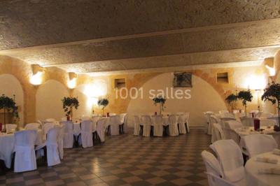 Décoration florale composée de roses, pivoines et feuillage, accrochée à une structure blanche en extérieur.