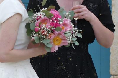Miniature bouquet coloré Un couple marche dans le jardin d'un château ancien entouré de verdure par une journée ensoleillée.